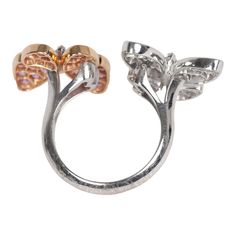 This Van Cleef & Arpels two butterfly "between the finger" ring features 18K rose gold, rhodium plated white gold, and 34 round pink sapphires diamonds of 0.88 carat each, and 36 white gold marquise-cut diamonds that are 0.99 carat each. Origin: FranceCondition: Pre-owned; Excellent - moderate Scratching to back of ringAccompanied by: VCA green jewelry box and authenticity card Measurements: Ring Size: 52 | US Size: 6 Luxury Butterfly Ring For Formal Occasions, Luxury Pink Flower Ring For Formal Occasions, Luxury Pink Flower Ring For Formal Events, Luxury Butterfly Ring With Diamond Accents For Formal Occasions, Elegant Butterfly Ring With Diamond Accents, Luxury Formal Butterfly Ring With Diamond Accents, Elegant Butterfly-shaped Rings With Diamond Accents, Formal Brilliant Cut Butterfly Ring, Formal Fine Jewelry Butterfly Ring With Prong Setting