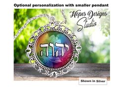 a necklace with the word happy designs studio written in hebrew on it and an image of a