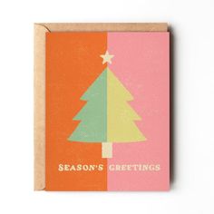 a card with a christmas tree on the front, and season's greetings below