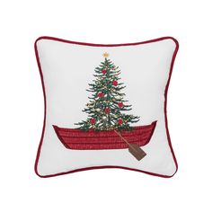 a pillow with a christmas tree on it and a paddle boat in the front,