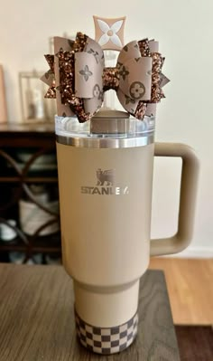 a cup with some decorations on top of it