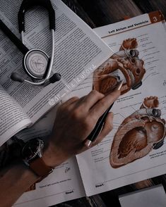 an open book with medical diagrams on it and a stethoscope next to it