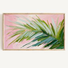 an abstract painting with palm leaves on a pink and green background in a wooden frame