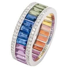 Introducing a mesmerizing rainbow ring, a stunning testament to the beauty of colored gemstones. Crafted with meticulous attention to detail, this ring features a dazzling array of different colored sapphire baguettes, arranged in a vibrant spectrum of hues. Set in lustrous 18k white gold, the ring is adorned with paved diamond edges, adding a touch of sophistication and sparkle to the design. Each sapphire has been carefully selected for its brilliance and clarity, making this ring a true statement piece that captures the essence of joy and elegance. Sapphires - 4.51 cts Natural Diamonds - .511 cts Ring Size - 5.5 Elegant Multicolor Brilliant Cut Gemstones, Formal Multicolor Diamond Gemstones, Luxury Multicolor Sapphire Ring With Gemstone Accents, Multicolor Brilliant Cut Sapphire Ring For Formal Occasions, Formal Multicolor Brilliant Cut Rings, Luxury Multicolor Multi-stone Sapphire Ring, Luxury Multi-stone Sapphire Gemstones, Luxury Multicolor Multi-stone Gemstones, Luxury Multicolor Gemstones With Accents