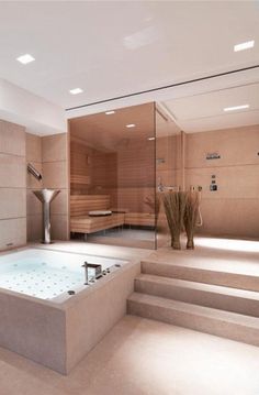 an indoor jacuzzi tub in the middle of a room with steps leading up to it