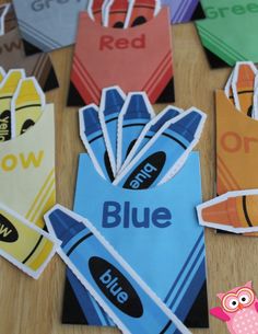 colorful paper bags with the word blue on them and an owl sitting in front of them