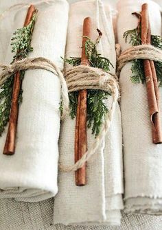 napkins wrapped in twine and tied with twine, cinnamon sticks and evergreen sprigs