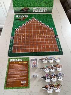 a board game sitting on top of a table next to some cards and magnets