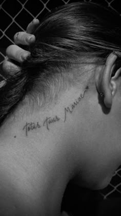 the back of a woman's neck with writing on it