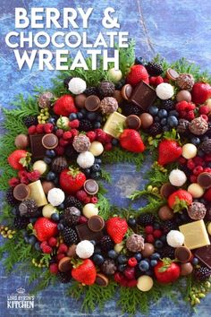 a wreath made out of berries, chocolates and strawberries with the words berry & chocolate wreath