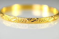 A vintage patterned heavy bangle bracelet in 23K yellow solid gold. The bracelet measures 5.5 mm wide and 1.5 mm thick The inside diameter is slightly under 2 1/4 inches best for a small wrist Metal: 23k yellow gold marked and tested Weighs 17.23 grams Jewelry from Stowe Vintage arrives beautifully packaged in a gift box. Shipped USPS First Class Insured If you have any questions about this piece or if we can help you with any of our other items please feel free to contact us. Gift 22k Gold Yellow Bangle, Vintage 14k Gold Hallmarked Bangle, Antique Yellow Gold Hallmarked Bangle, Yellow 22k Gold Bangle With Intricate Design, Vintage Etched Yellow Gold Bangle, Kimberly Brown, Solid Gold Bangle, Stowe Vt, Star Ruby