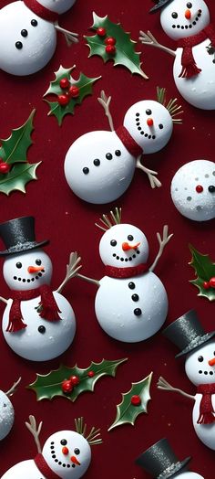 several snowmen with hats, holly and mist on a red background that looks like christmas decorations