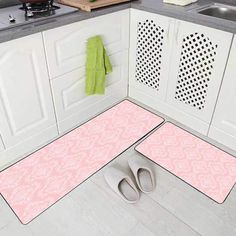 two pairs of slippers sitting on the floor in a kitchen