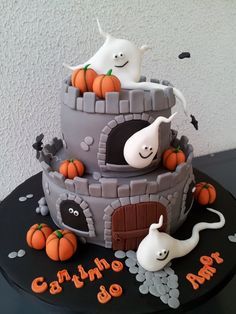 a halloween cake with ghost and pumpkins on the top is for someone's birthday