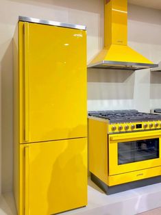 a yellow stove top oven sitting inside of a kitchen