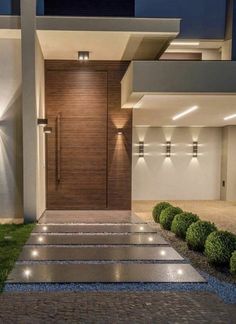 the entrance to a modern home at night