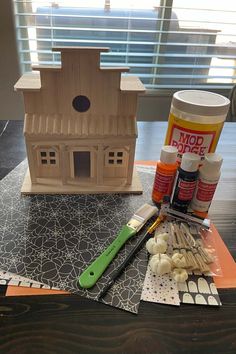 the table is covered with crafting supplies such as paint, scissors and glue