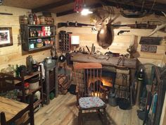 a room filled with lots of clutter and wooden shelves next to a fire place