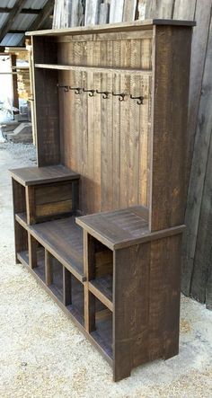 an old wooden bench with two benches underneath it and some shelves below the bench that are made out of wood