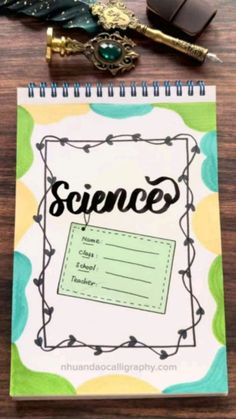 a notebook with the word science written on it next to a pen and quill