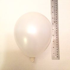 a white balloon with a measuring tape attached to it