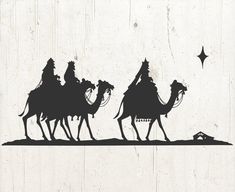 three wise men riding on camels in the desert