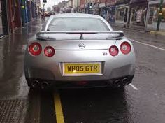 a silver sports car parked on the street