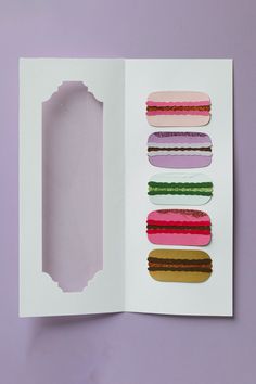 an open book with different colored doughnuts on it