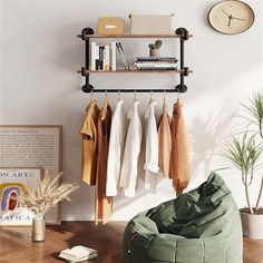 a living room with clothes hanging on a rack and a bean bag chair in the foreground