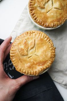 two pies sitting next to each other on top of a table