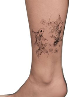 a woman's foot with two goldfish tattoos on it