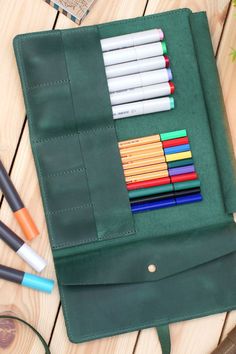 Our Leather Pencil Roll - high quality pencil case made of genuine leather. These are a great gift idea for anniversary, housewarming, birthday, christmas and etc. Available in 5 colors: Blue, Deep Green, Cognac, Graphite and Dark Olive. Size: Closed: 8 1/2" x 5" (21.5 x 12.5 cm) Open: 8 1/2" x 13 3/4" (21.5 x 35 cm) Green Pencil Shaped Case With Pen Slots, Green Pencil-shaped Case With Pen Slots, Personal Use Pencil Case With Pen Slots, Green Pencil Case With Pen Slots For Daily Use, Green Pencil Case With Pen Holders For Organization, Green Pencil Case For Personal Use, Leather Pencil Case With Pen Slots For School, Green Pencil Case With Pen Slots, Green Travel Stationery With Pen Holders