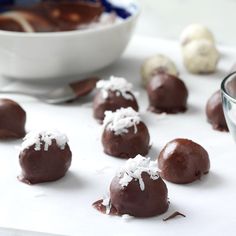 chocolate truffles with coconut on top and bowl of sea salt in the background