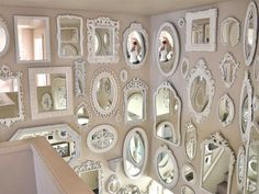 there are many mirrors on the wall in this room