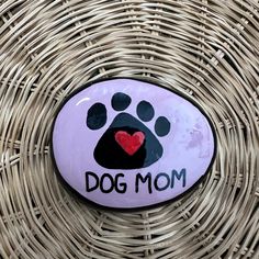 a rock with a dog's paw painted on it that says, dog mom