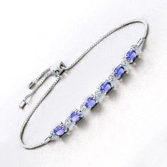 Tanzanite Bracelet, Real Tanzanite Oval Bolo Bracelet in .925 Sterling Silver, December Birthstone, Anniversary Gift, Bridesmaid Gift This 1.98-carat genuine tanzanite bolo bracelet showcases the enchanting allure of tanzanite in a sleek .925 sterling silver setting. The vibrant stones are arranged along a delicate chain, allowing their stunning color to take center stage. The bolo design offers both comfort and style, making this bracelet a versatile accessory that adds a sophisticated touch to Silver Birthstone Bracelets For Formal Occasions, Silver Birthstone Bracelets, Silver Birthstone Bracelet For Formal Occasions, Formal Silver Bracelet With Birthstone, Adjustable Oval Fine Jewelry Bracelet, Formal Silver Birthstone Bracelets, Adjustable Oval Jubilee Bracelet, Oval Sapphire Bracelets As Gift, Elegant Adjustable Oval Crystal Bracelet