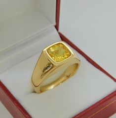 Gemstone: Yellow sapphire A gem certificate of authenticity will be provided at no charge. Treatments: Heated/Lattice Diffusion Specifications: 8.03x8.1mm, approx. 2.89 carats Color: As shown Stunning rare lemon yellow Clarity: Eye clean, almost loupe clean Cut: Cushion cut Weight: 16 grams. Ring size: 10, with all sizes available from 6.5 through 12 This is as fine and elegant a man's ring as you will ever find. The perfect blend of a fine gemstone matched up with a clean classic 14K yellow gol Luxury Yellow Gold Men's Ring With Bezel Setting, Yellow Stone Ring Men, Safire Rings, Indian Wedding Suits Men, Mans Ring, Yellow Stone Rings, Gold Jewelry Outfits, Yellow Sapphire Rings, Suits Men