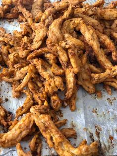 fried food sitting on top of a piece of paper