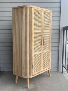 a wooden cabinet sitting on top of a porch