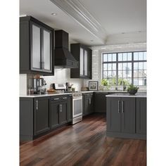 a kitchen with dark gray cabinets and wood flooring is shown in front of a large window