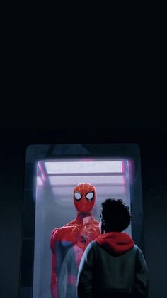 the spider man standing in front of a mirror with his head turned to look at himself