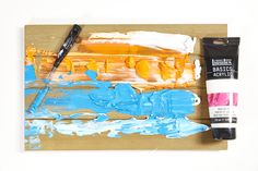 the paint is being used to create an abstract painting on wood planks with acrylic colors