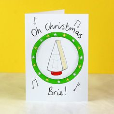 a christmas card with an ornament in the shape of a sailboat on it