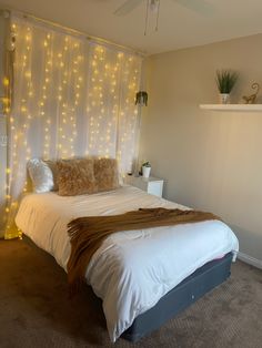 a bed with lights on the wall behind it