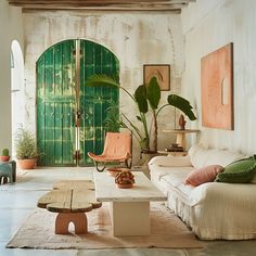 a living room filled with lots of furniture next to a green door on the wall