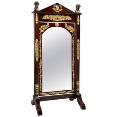 an ornately decorated wooden mirror cabinet