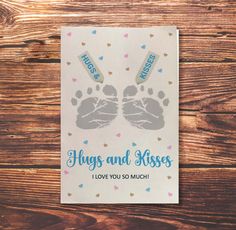 a card that says hugs and kisses i love you so much with two baby footprints