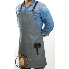 a man wearing an apron with the letter t on it's chest and holding his hands in his pockets