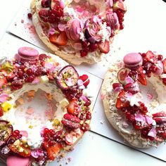 two desserts with strawberries and other toppings on top of each one in the shape of a wreath