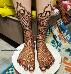 the legs and feet of a woman with henna tattoos